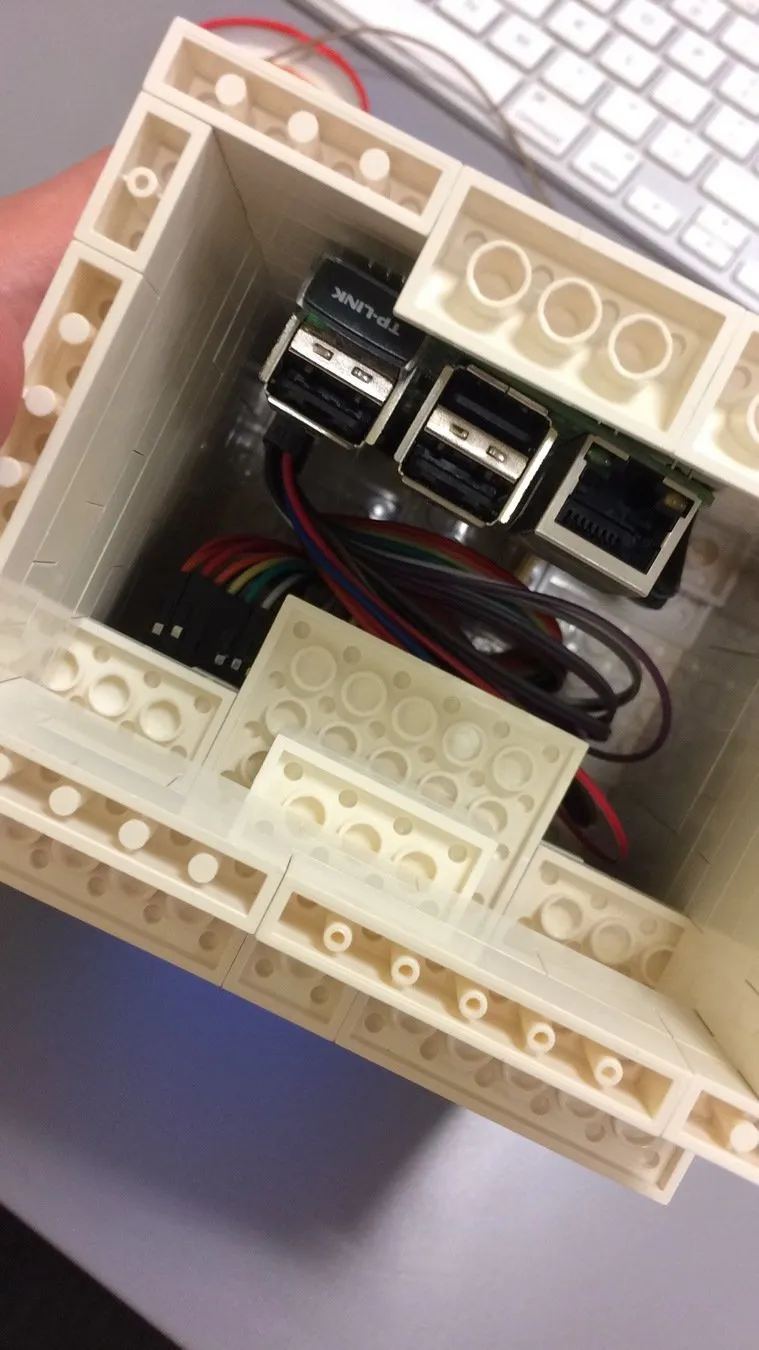 The underside of the brick case: a Raspberry Pi with USB and Ethernet ports, and cables, inside