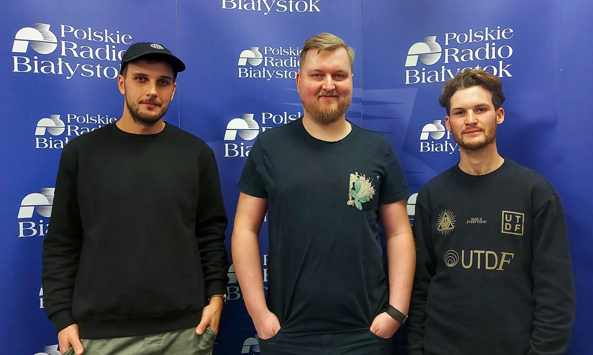 Three men standing in front of a Polskie Radio Białystok backdrop