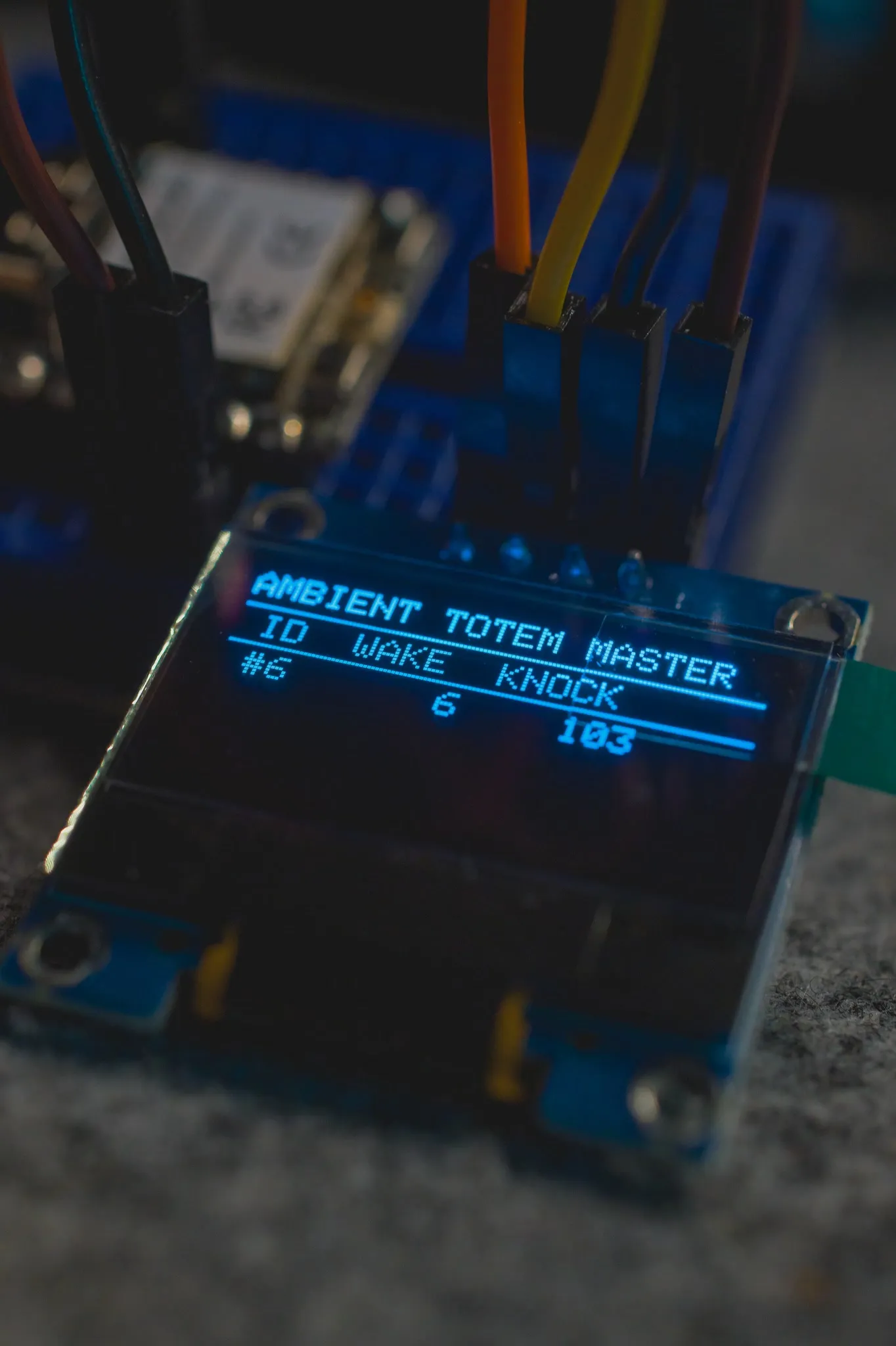 A small blue display reading AMBIENT TOTEM MASTER with ID, WAKE and KNOCK columns